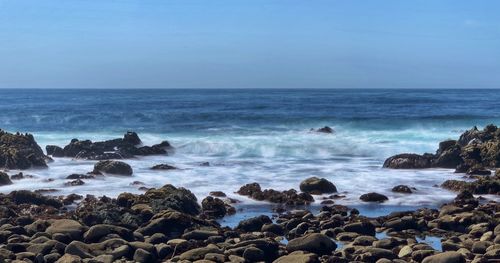 Rocky coastline of pacific grove california  with blue skies and slow shutter 
