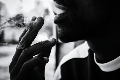 Close-up of man holding cigarette