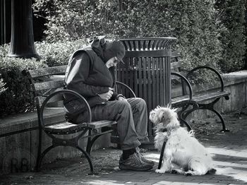 Man with dog sitting on chair