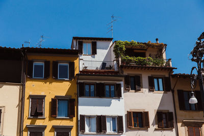 Low angle view of buildings against blue sky