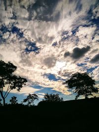 Low angle view of silhouette trees against sky at sunset