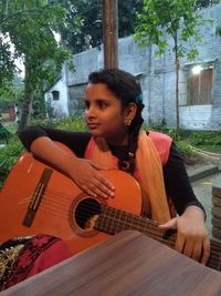 Young woman playing guitar