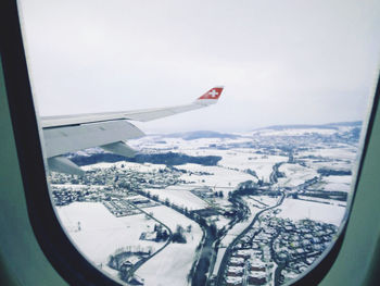 Aerial view of cityscape seen through airplane window