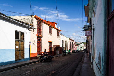 Street amidst buildings against sky in city