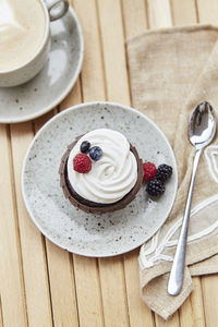 Natural gluten and sugar free berries tender cupcake and cup of coffee. . cozy breakfast 