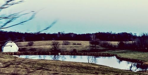 Scenic view of lake against sky during winter