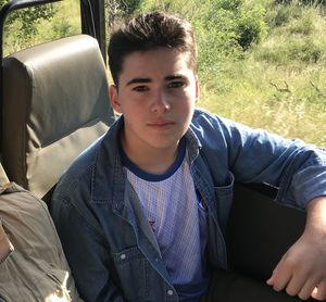 Portrait of young man sitting outdoors