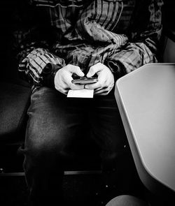 Rear view of man sitting on bench