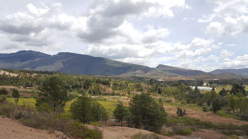 Scenic view of mountains against cloudy sky
