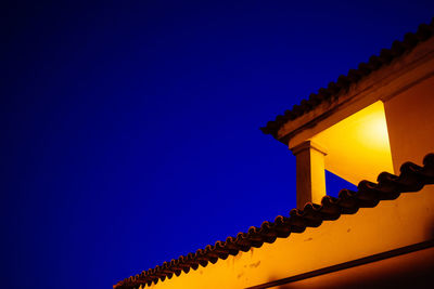 Low angle view of built structure against clear blue sky