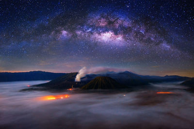 Scenic view of mountains against sky at night