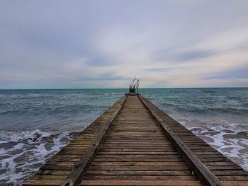 Pier over sea against sky