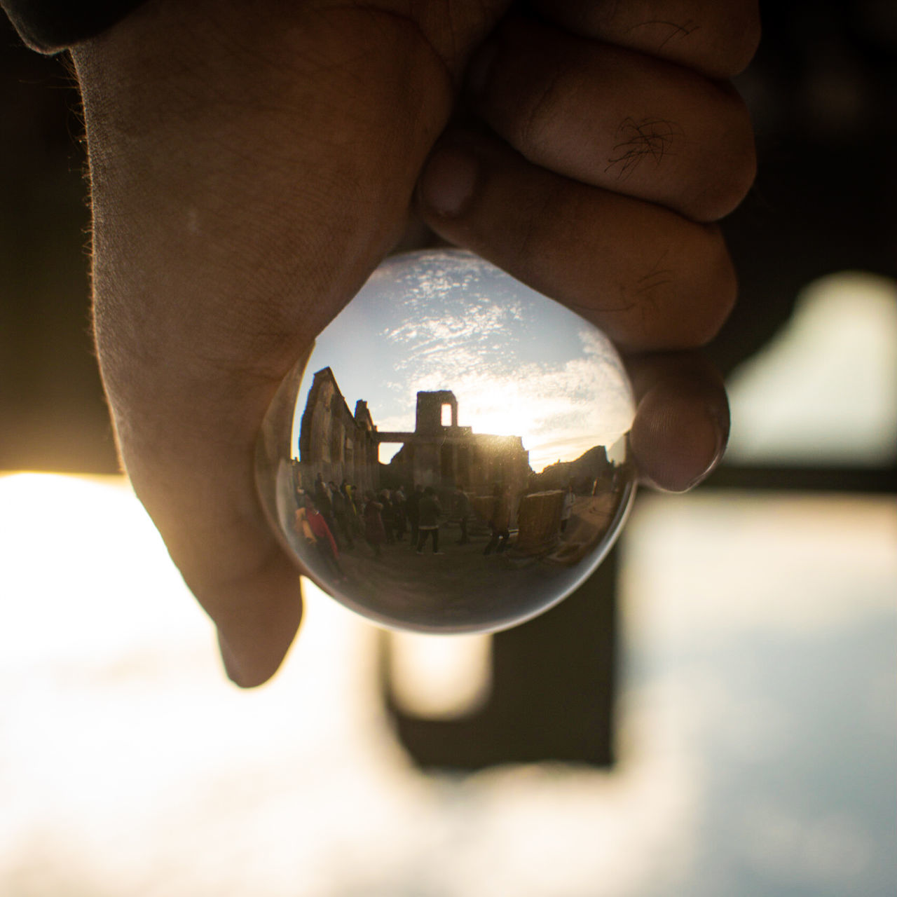 human hand, hand, human body part, sphere, one person, holding, crystal ball, focus on foreground, crystal, close-up, reflection, finger, human finger, body part, unrecognizable person, glass - material, nature, day, transparent, outdoors