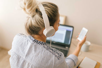 Rear view of woman using mobile phone