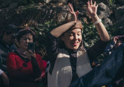 Happy young woman standing in traditional clothing