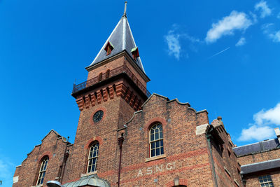 Low angle view of building against blue sky