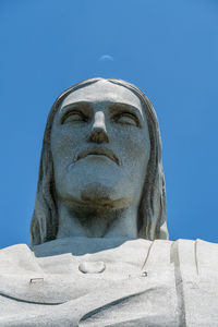 Low angle view of statue against blue sky