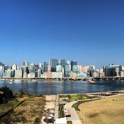 View of cityscape against clear blue sky