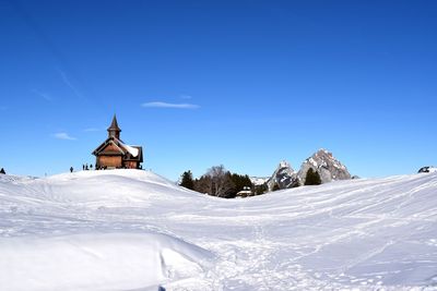 Snow covered temple against blue sky