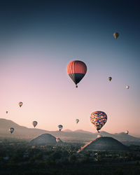 Low angle view of hot air balloons flying in sky