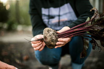 Midsection of man holding snail