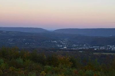 Scenic view of mountains against sky at sunset