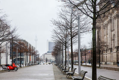 Street amidst buildings in city against sky