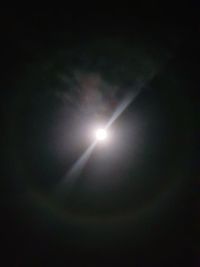 Low angle view of illuminated lights against sky at night