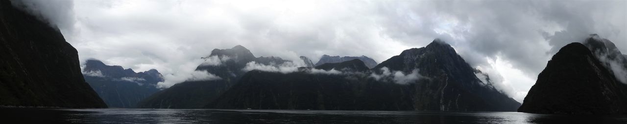 Panoramic view of sea and mountains against sky