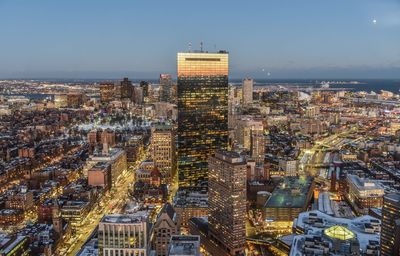 High angle view of city lit up at night