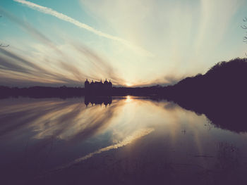 Scenic view of lake against sky during sunset