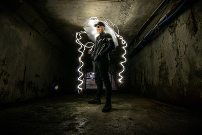 Full length of young man standing in tunnel