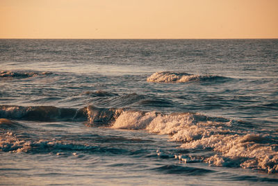 Scenic view of sea against clear sky during sunset