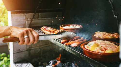 Cropped hand of man preparing food