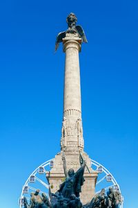 Low angle view of statue against blue sky