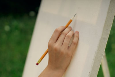 Close-up of hand holding cigarette