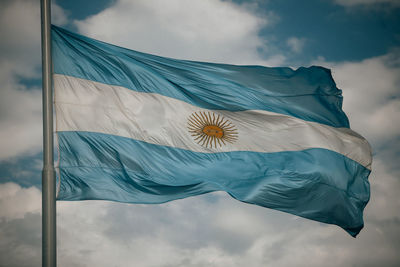 Low angle view of argentinian flag waving against sky