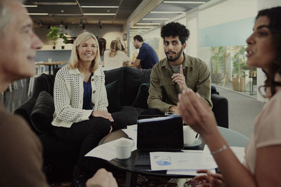 Group of business people having meeting in lobby