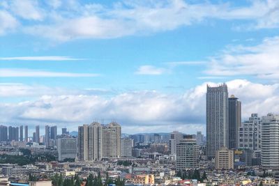 Modern buildings in city against sky