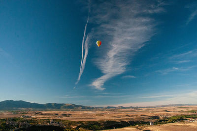 Low angle view of vapor trail against blue sky