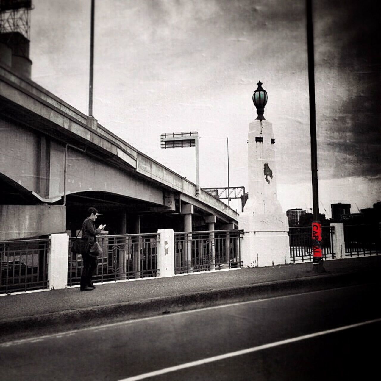 transportation, architecture, built structure, sky, building exterior, road, road marking, cloud - sky, the way forward, street, mode of transport, road sign, street light, city, land vehicle, day, railing, connection