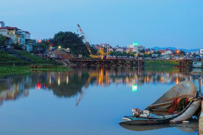 Boats moored in water against clear sky