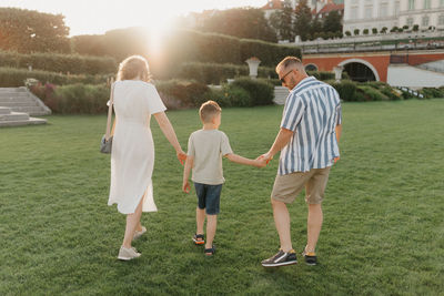 Rear view of couple standing on field