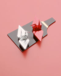 High angle view of gift box against pink background