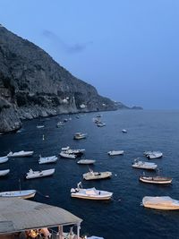 High angle view of boats moored in sea against clear sky