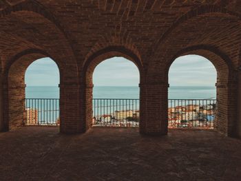 View of sea seen through arch window