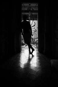 Full length of silhouette man standing in darkroom