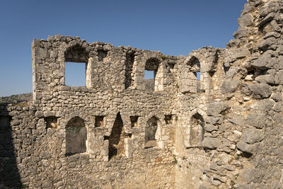 Low angle view of old ruins against clear sky