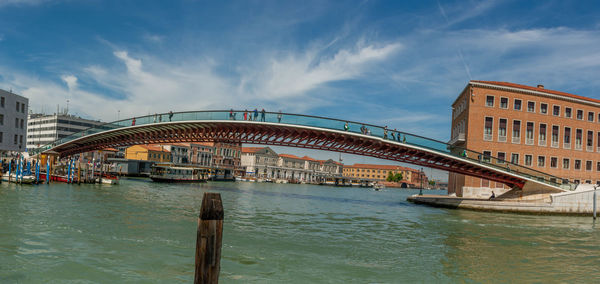 View of bridge over river against cloudy sky