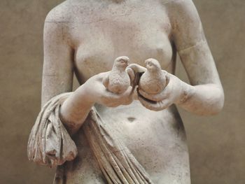 Close-up of female and animal statue